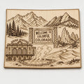 Front close-up of Colorado Engraved Birch Wood Wall Art Mountain Landscape Travel Sign, showing dark engraving on natural birch wood.