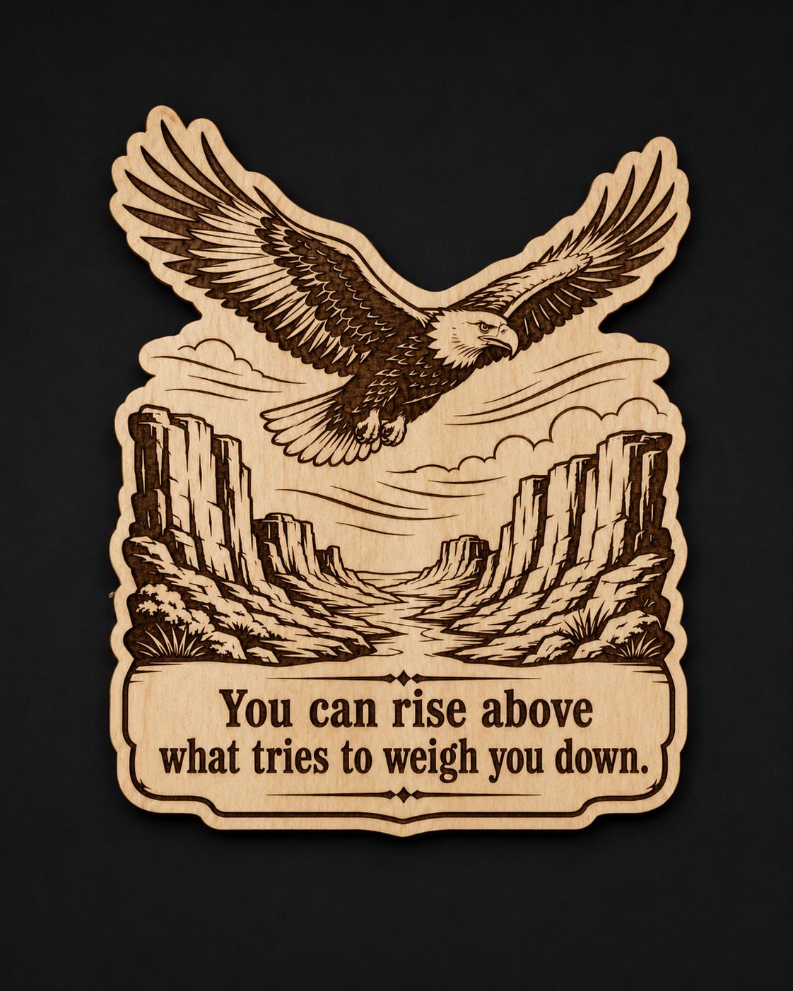 Front close-up of Eagle Wood Sign Rise Above Quote Birch Plaque Canyon Wall Decor Inspirational Gift, showing dark engraving on natural birch wood.