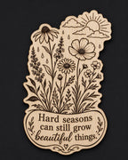 Front close-up of Wildflower Wood Sign Hard Seasons Quote Birch Plaque Inspirational Floral Wall Decor, showing dark engraving on natural birch wood.