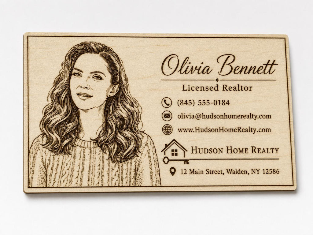 Close front view of a personalized engraved birch realtor card with portrait and contact details.