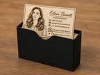 Personalized engraved birch realtor card standing upright in the included black card holder.