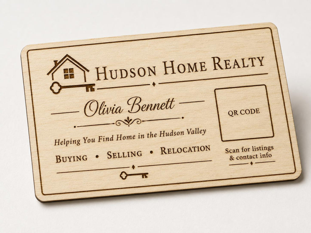 Back view of a personalized engraved birch realtor card with logo, message, QR code, and contact details.