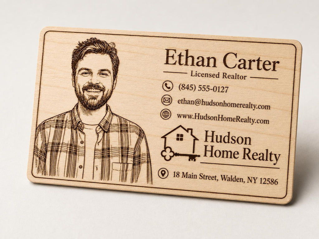 Close front view of a second personalized engraved birch realtor card with portrait and contact details.