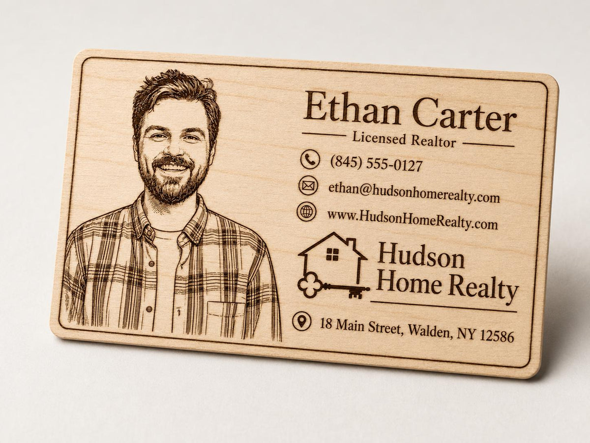 Close front view of a second personalized engraved birch realtor card with portrait and contact details.