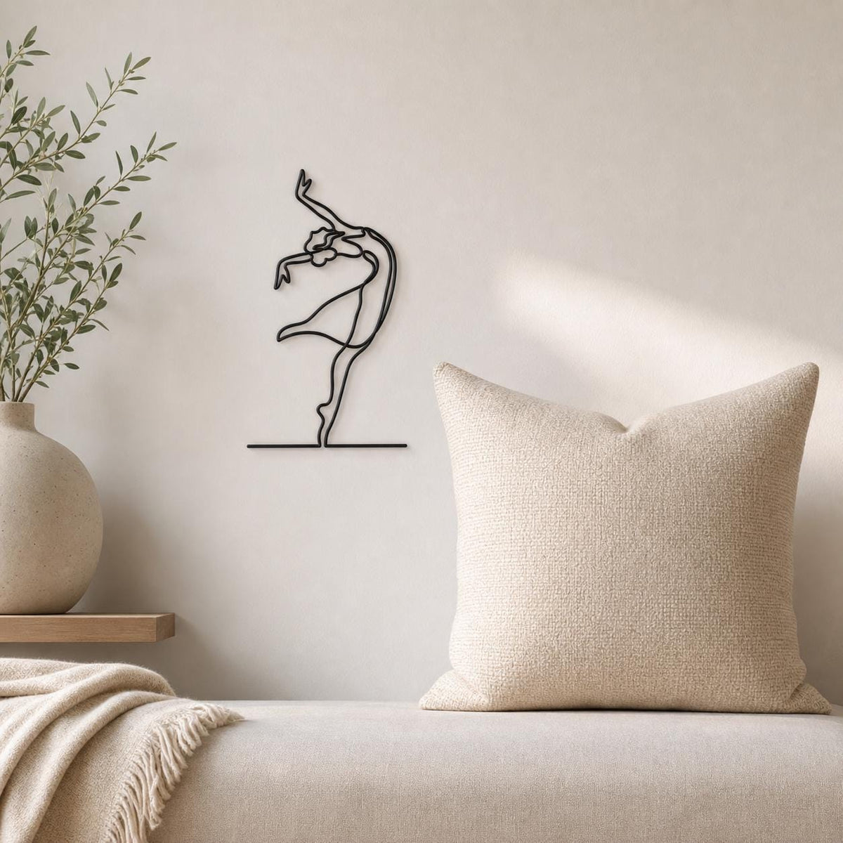 Reclining Dancer wall art in black, shown at 12-inch scale in a modern living room