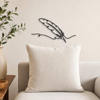 Feather Quill wall art in black, shown at 12-inch scale in a modern living room