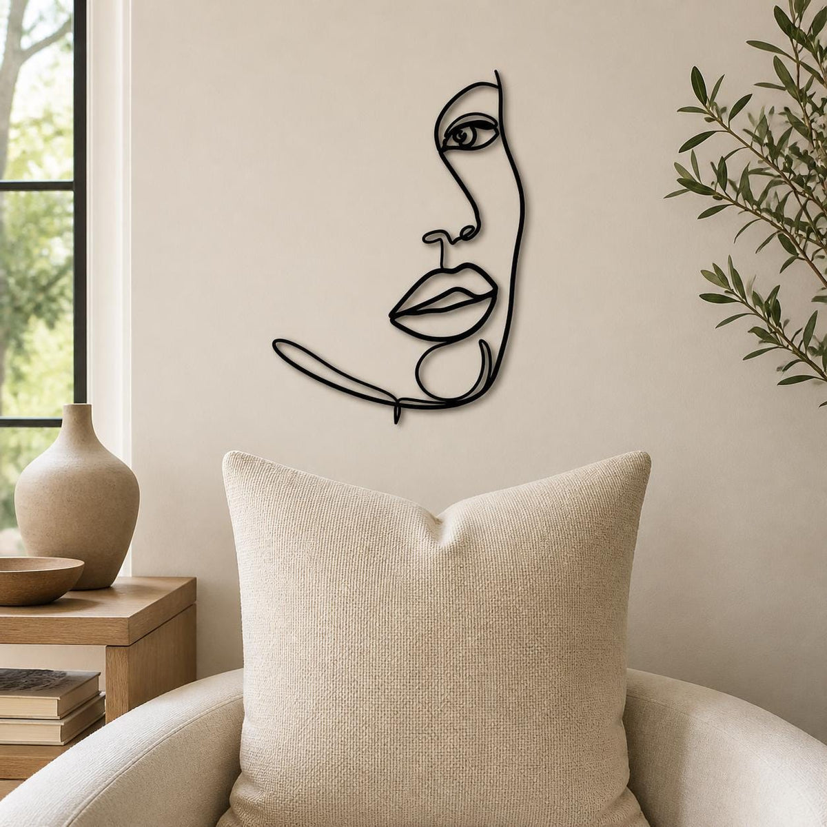 Half Face Woman wall art in black, shown at 12-inch scale in a modern living room