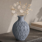 Close-up of the Blue Grey CanopyMuse leaf relief vase with pale lunaria and oat stems