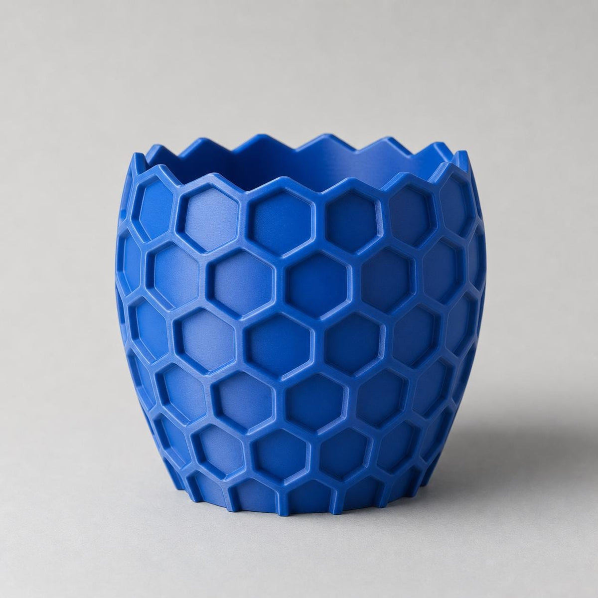 Elevated close-up of the empty HexaGrove planter in Cobalt Blue showing its zigzag rim