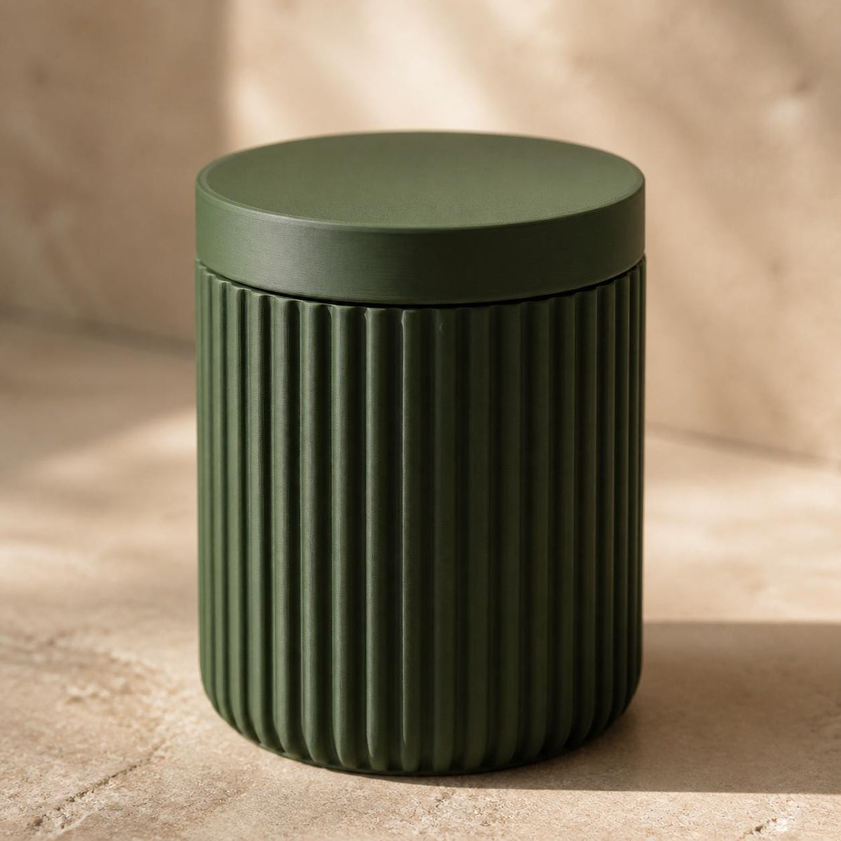 Close-up of the Solenne closed lidded storage jar in Dark Green
