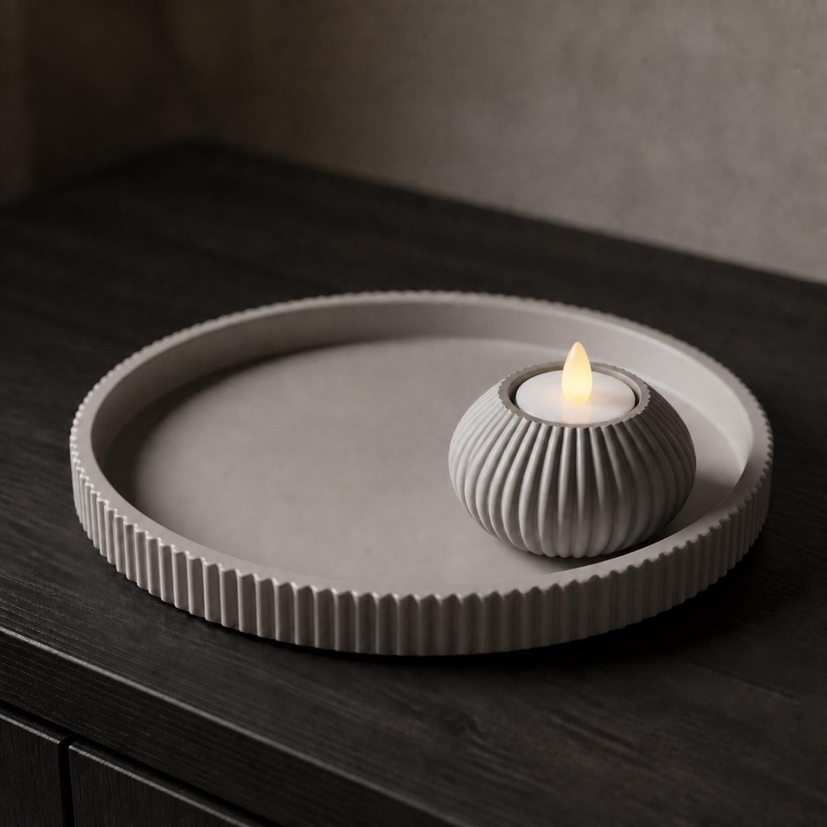 Close-up of the Solenne LED tealight holder and foundation tray in Ash Gray