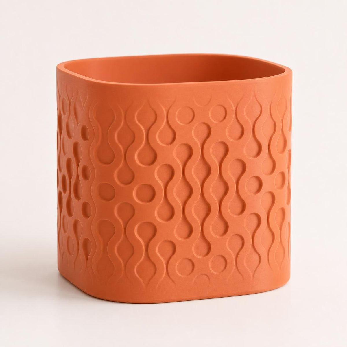 Close-up three-quarter view of the Tidecell rounded square planter in Terracotta