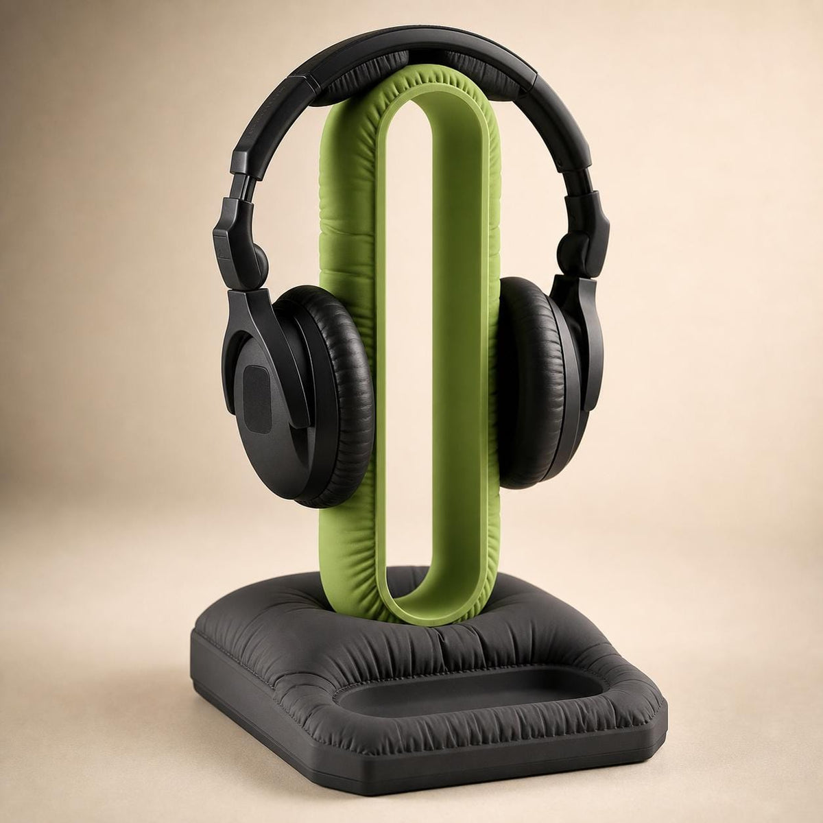 Close-up of the CushionLoop Organizer Base headphone stand in Apple Green and Charcoal holding black headphones