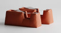Two complete DrapeCut tape dispenser style options in Terracotta on a plain background