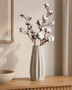 Close-up of an Ivory White Loomrise ribbed vase with dried cotton stems