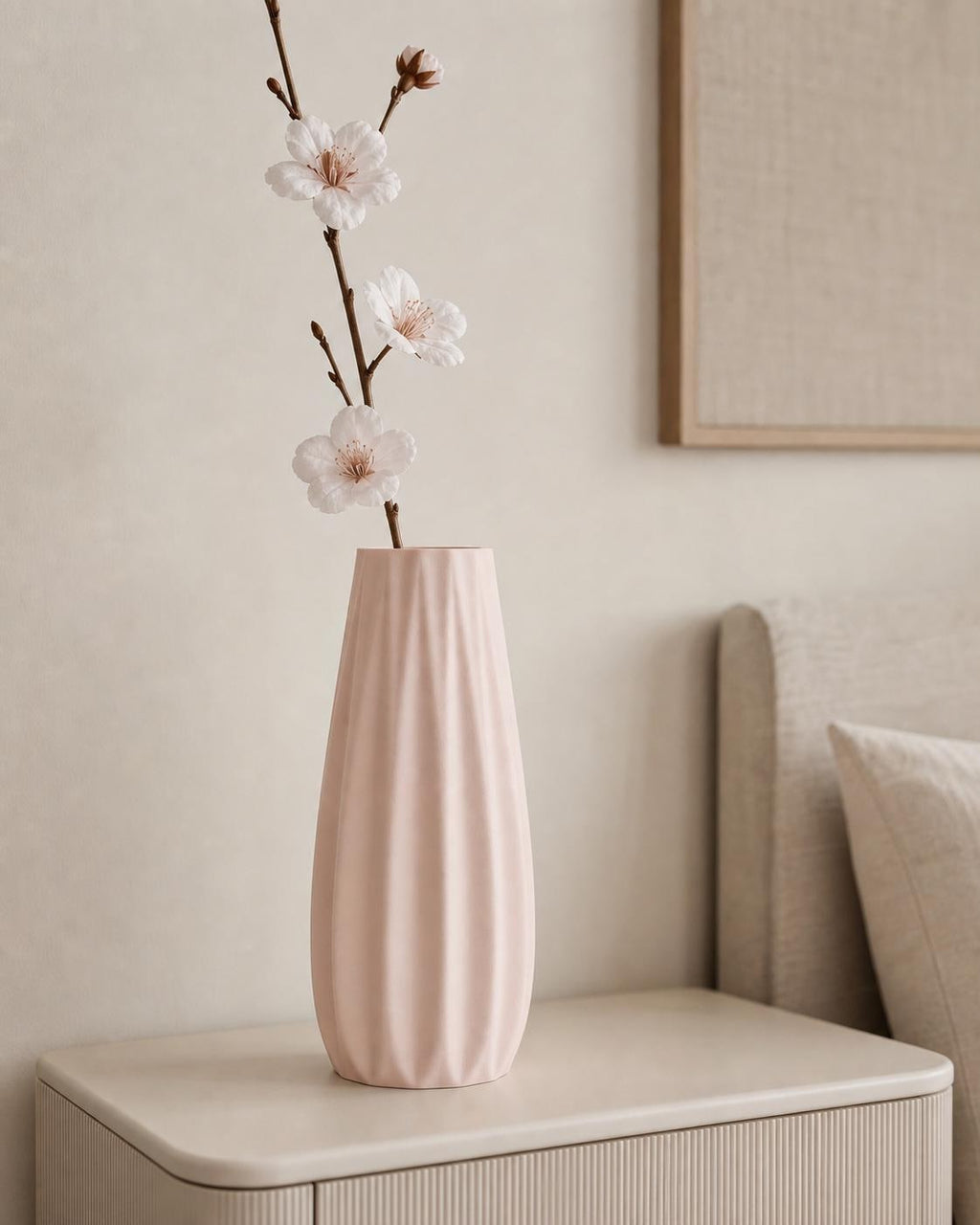 Close-up of a Sakura Pink Loomrise vase with delicate dried stems