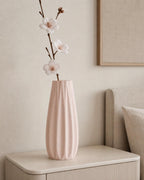 Close-up of a Sakura Pink Loomrise vase with delicate dried stems