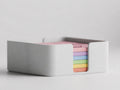 Close-up of the complete TactileBloom six-color coaster assortment stacked in its Ivory White holder
