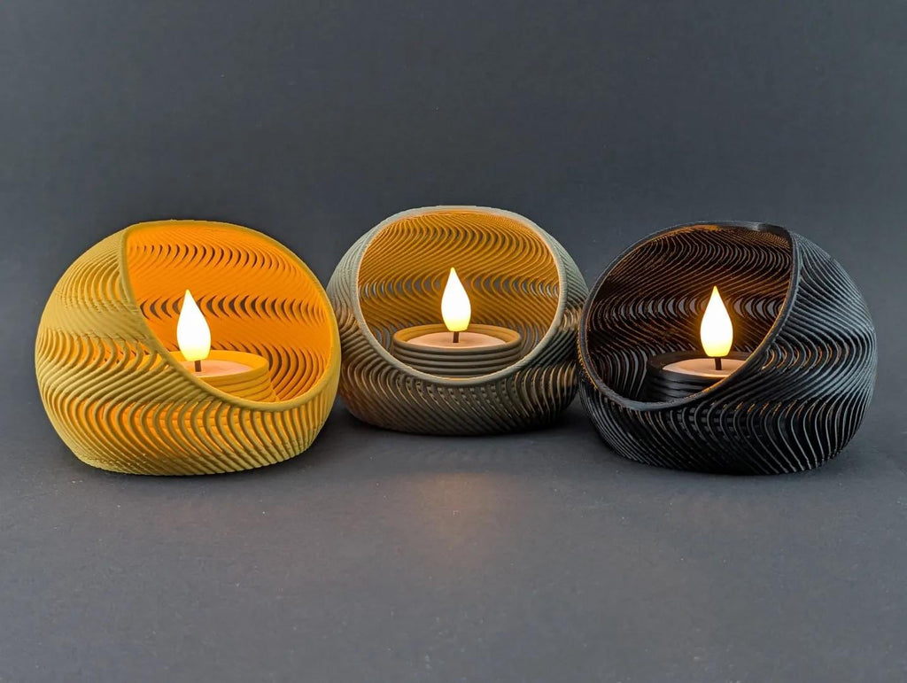 Three TideNest ripple holders in yellow gray and charcoal with warm LED tea lights
