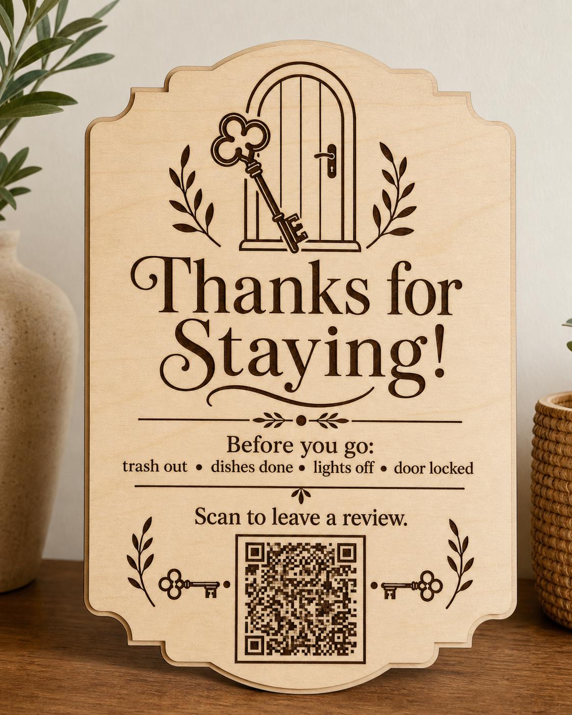 HearthKey engraved birch review sign upright on a warm vacation-rental console, shown close up with a finished sample QR code.
