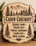 TimberTrail engraved birch cabin checkout sign upright on a cozy cabin entry console in a close-up view.