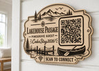 Lakehouse Passage WiFi Sign engraved birch sign mounted on a realistic neutral interior wall from a close side angle in natural birch and dark engraving, showing the QR code and guest network details.
