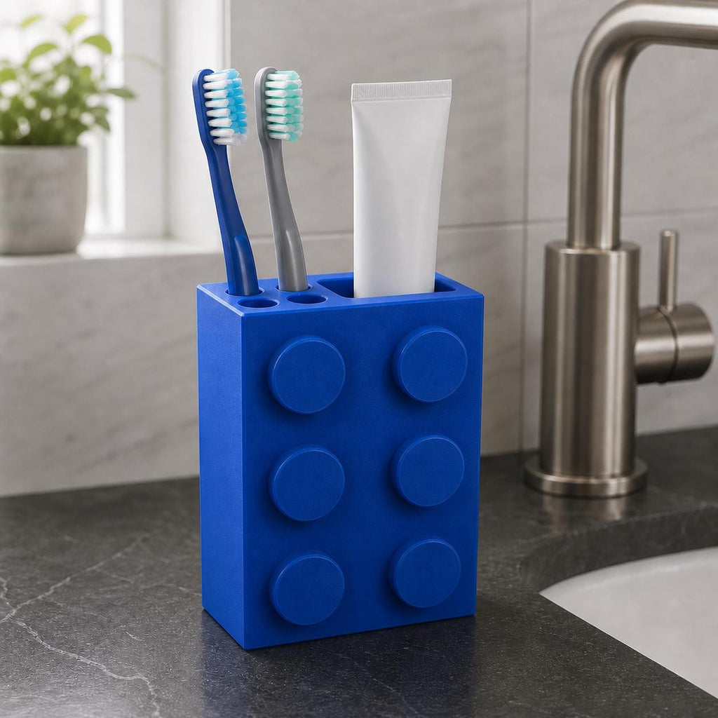 Blue block-style toothbrush organizer on a dark stone bathroom sink
