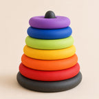 Rainbow Rise RingRise sequencing tower against a warm ivory background, low side view highlighting six rounded ring profiles and stable charcoal base.