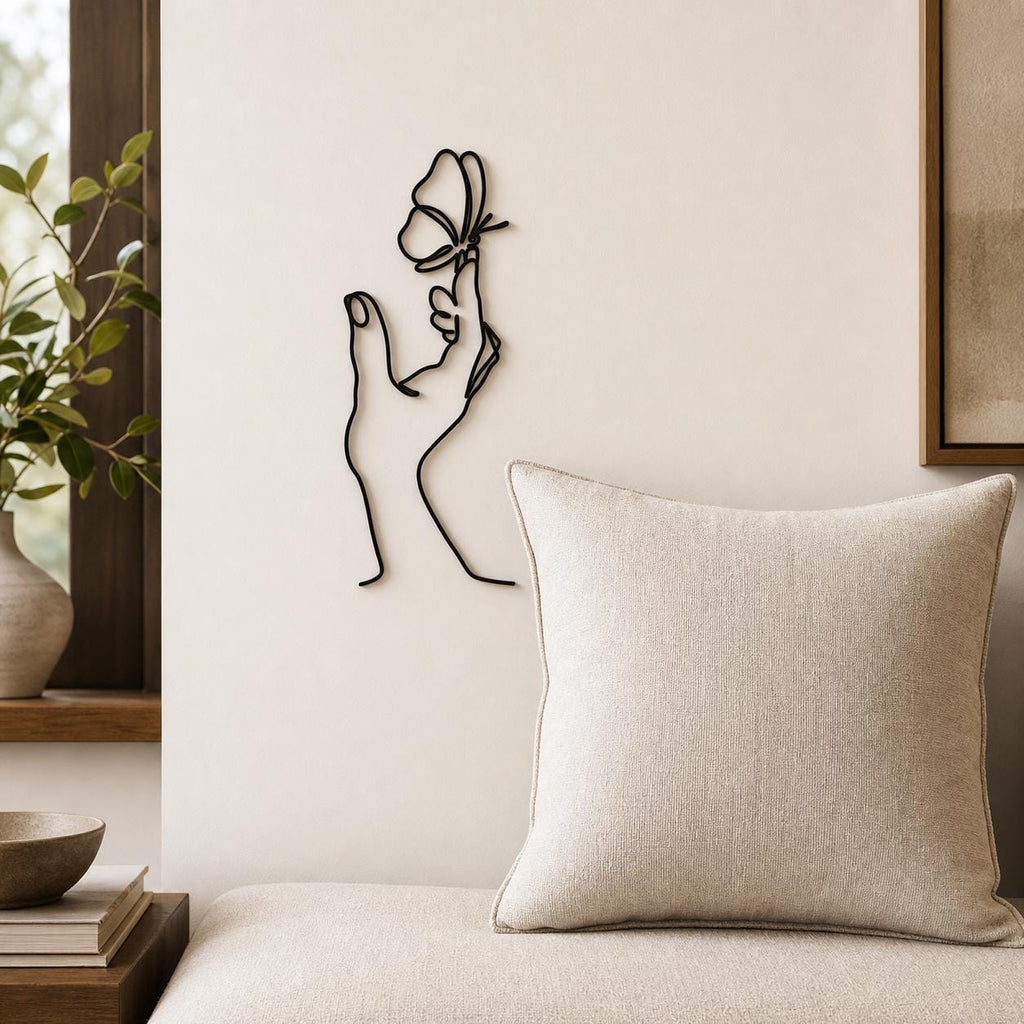 Butterfly Hand wall art in black, shown at 12-inch scale in a modern living room