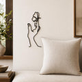 Butterfly Hand wall art in black, shown at 12-inch scale in a modern living room
