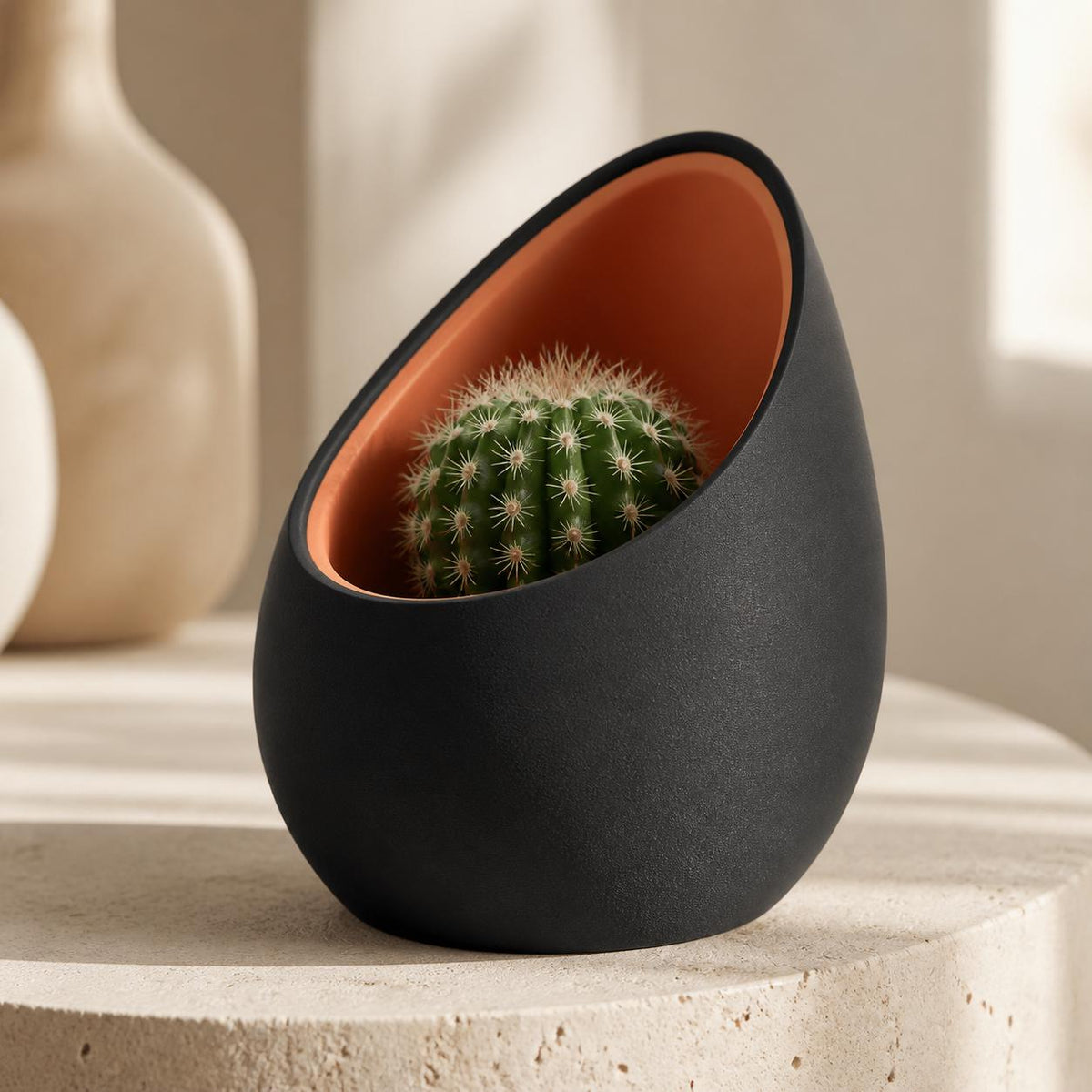 Close-up of the CovePod planter in Ember Nest with Charcoal outer and Terracotta inner