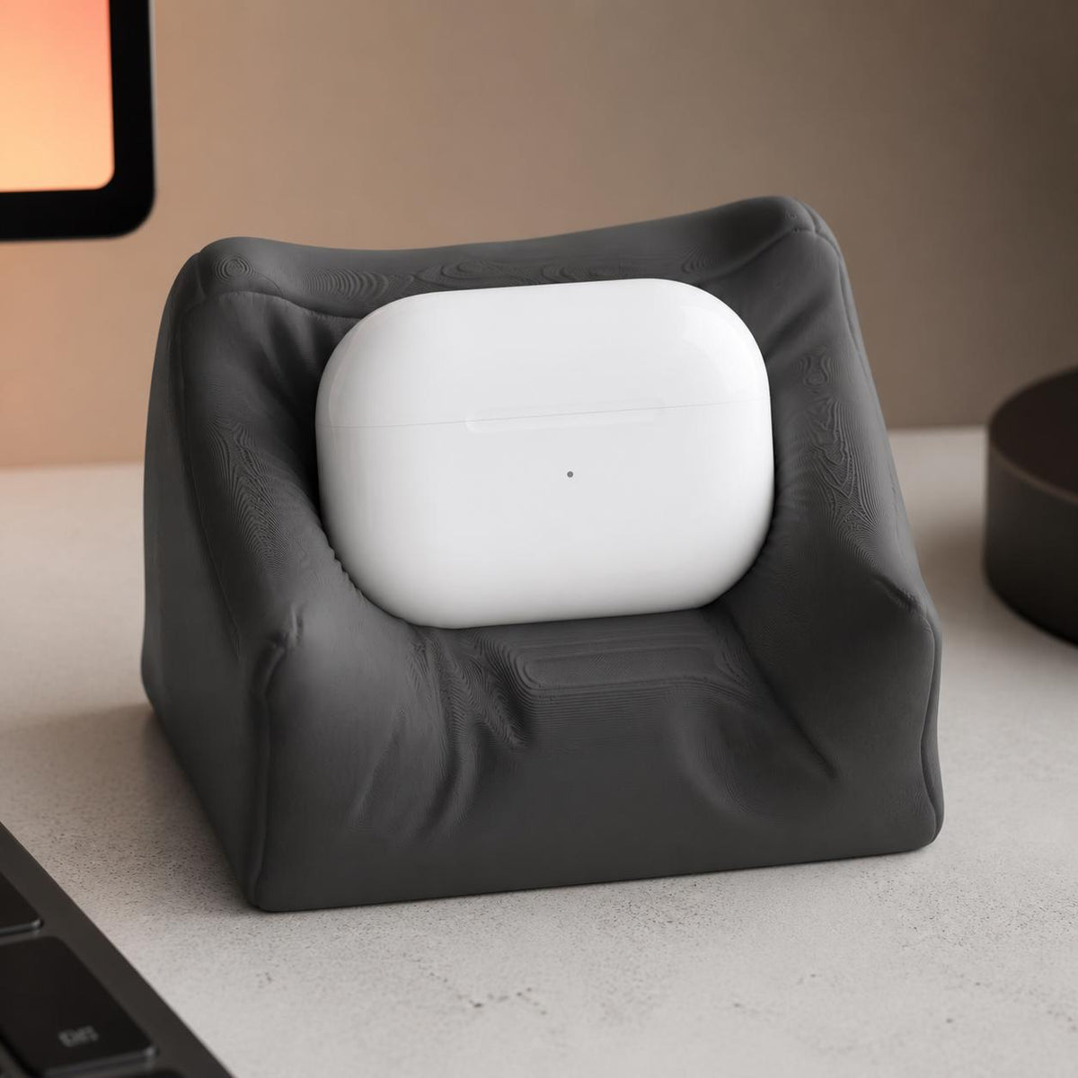Close-up of the Charcoal PillowPod stand emphasizing its sculpted cushion folds
