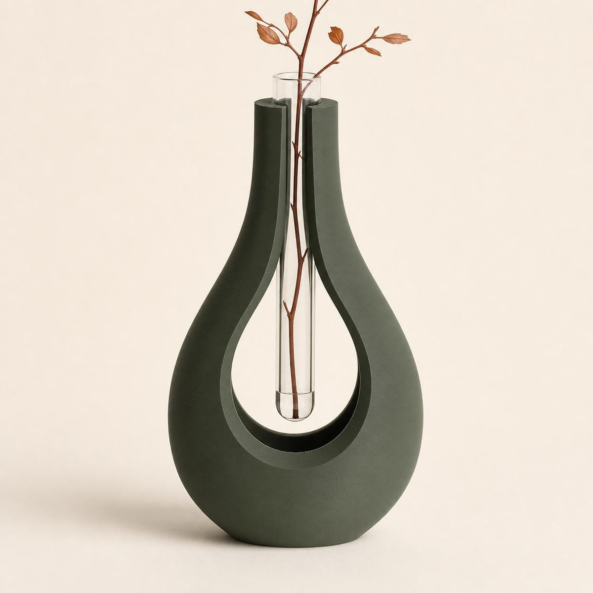 Close-up of the AerialArc floating stem vase holder in Dark Green with a clear 15 mm tube and dried botanical