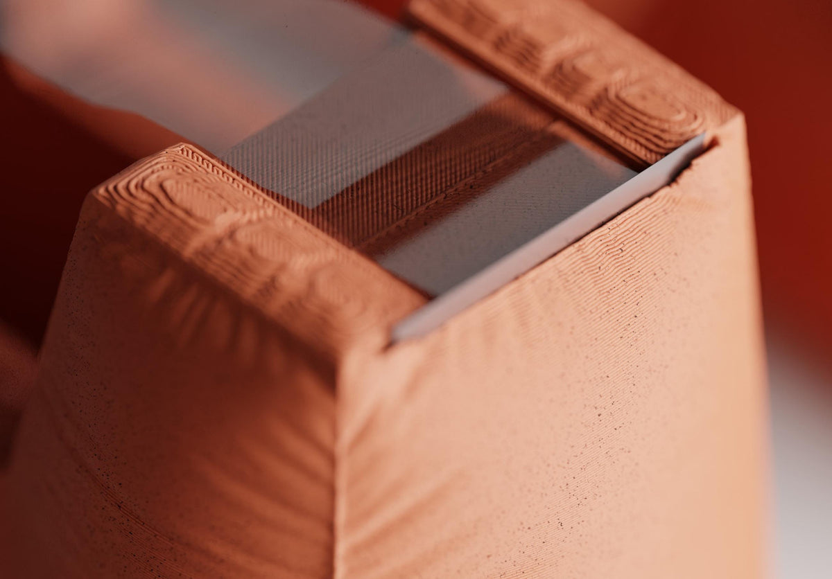 Close-up of a DrapeCut tape dispenser in Terracotta showing its gathered fabric-look texture