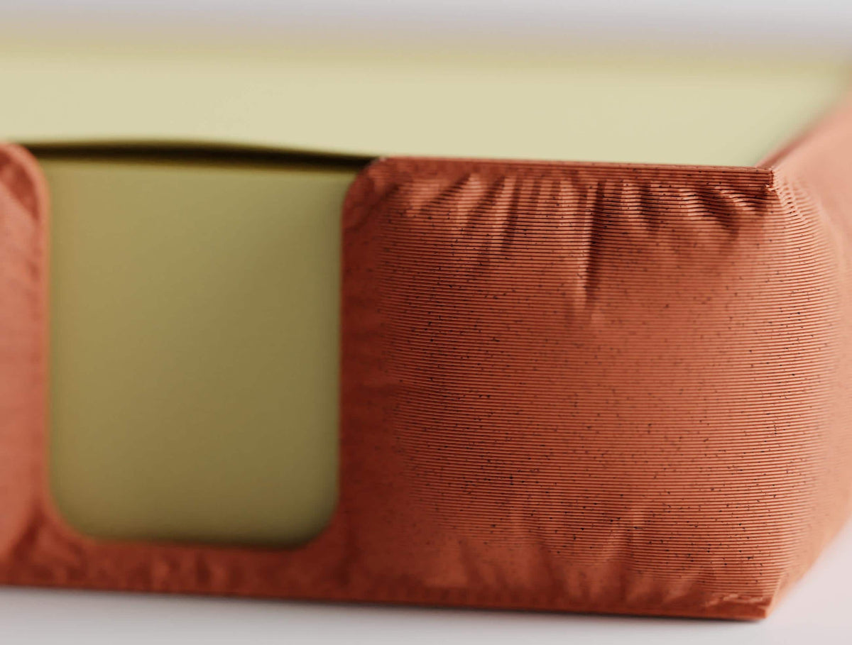 Close-up of the GatherPad holder's gathered fabric-look plastic surface