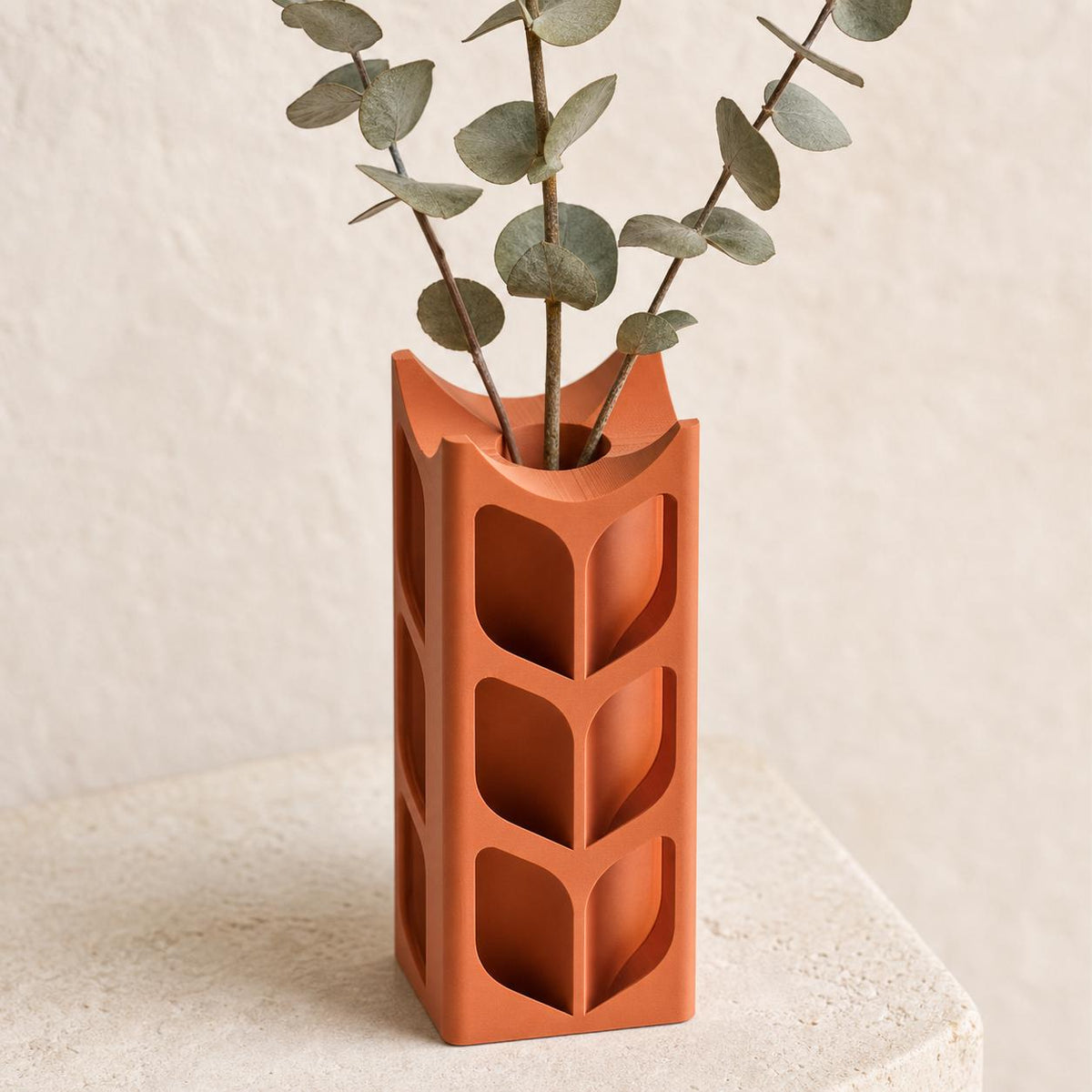 Close-up of the ArborLume leaf window vase in Terracotta with dried eucalyptus stems
