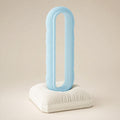 Close-up of the CushionLoop Classic Base headphone stand in Ice Blue and Bone White
