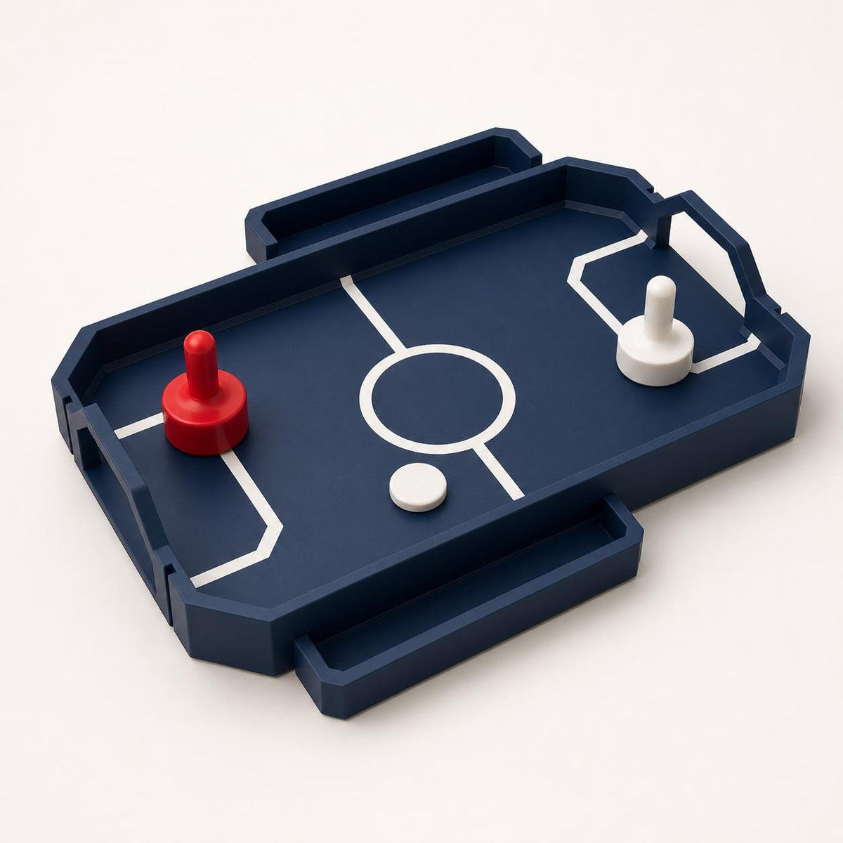 Close front-left view of the fully assembled RinkRush table hockey game in Dark Blue, Scarlet Red, and Ivory White on a warm white background