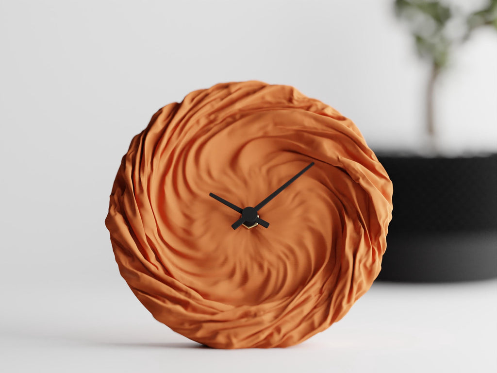 FoldWhirl sculptural wall clock in orange with flowing folded texture