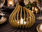 Gold FlareNest LED tealight holder glowing on a formal gala event table