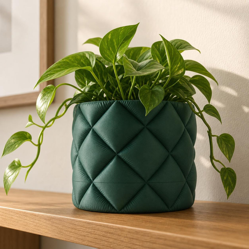 Close-up freestanding QuiltHaven quilted planter with a trailing pothos in a modern room