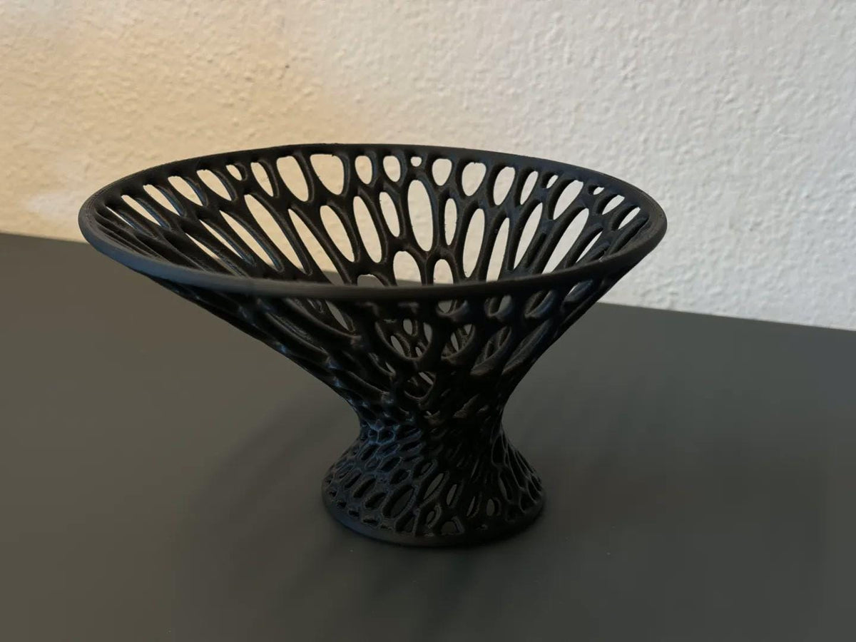 Angled close-up of the LatticeFlare sculptural bowl in charcoal