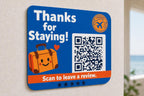 JetSet Thanks multicolor landscape travel review sign mounted on a light wall from a close side angle with a finished sample QR code.