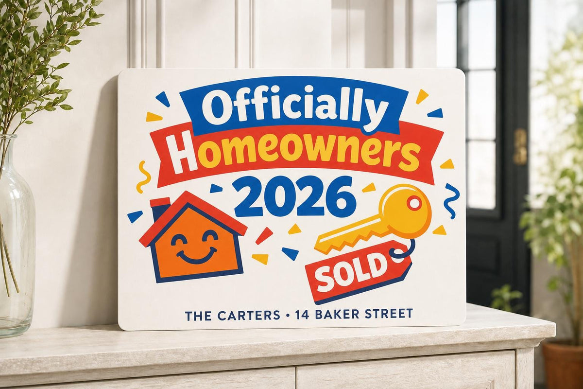 Officially Homeowners colorful sign shown close up with a smiling house, gold key, sold tag, and 2026.