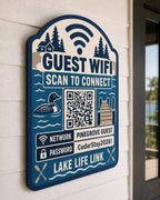 Lake Life Link Guest WiFi Sign textured multicolor sign mounted on a realistic neutral interior wall from a close side angle in navy, lake blue, taupe, and cream, showing the QR code and guest network details.