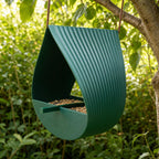 Forest Green Ribbon Roost ribbed loop bird feeder hanging in a garden