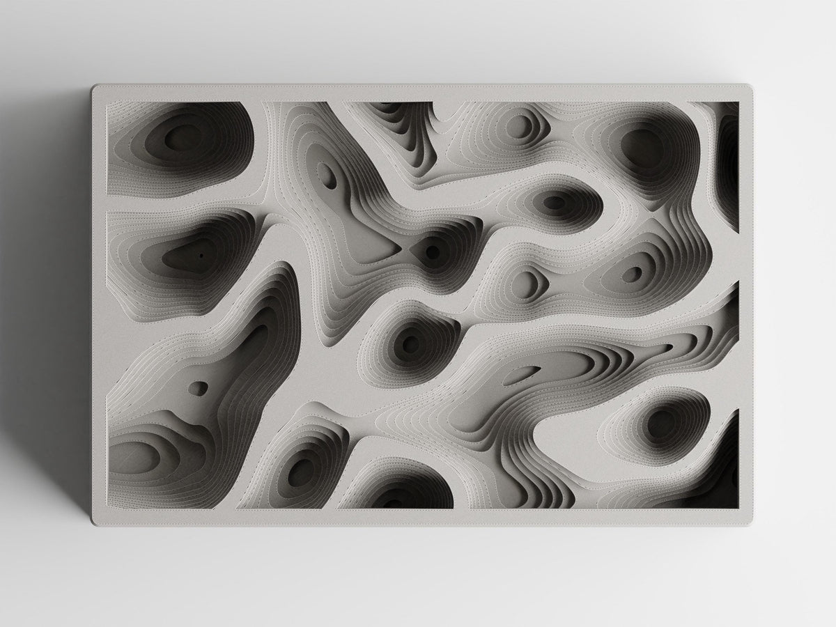 Overhead view of the empty ContourCove Organizer Tray showing its fixed topographic wells