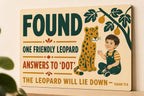 Flat color Friendly Leopard Found wall sign with visible-faced illustrated people, close angled view in a realistic room showing the thin finished edge.