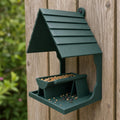 Forest Green Shinglecrest Landing wall bird feeder mounted on a cedar garden fence