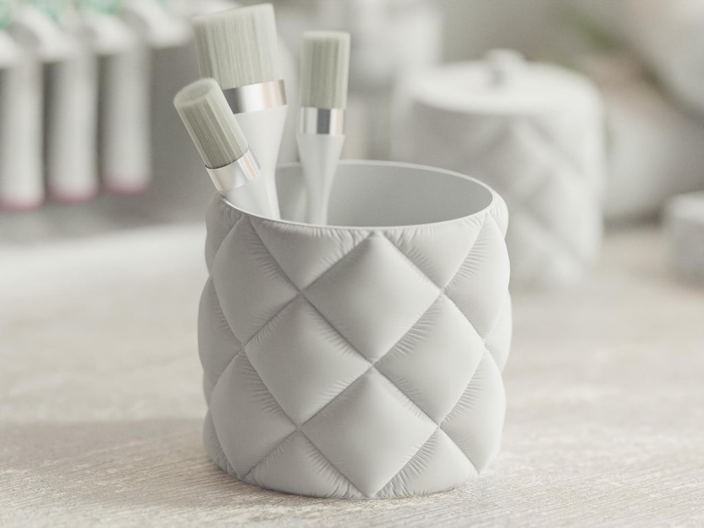 Close-up of the QuiltedCloud round organizer cup holding cosmetic brushes